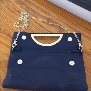 Navy clutch foldable or use 25” chain. Magnetic secure snaps. 6x9 roomy interior